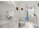Bright bathroom with a white vanity, toilet and shower and tub combo at 11140 Sw 53Rd Cir, Ocala, FL 34476