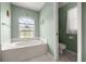 Relaxing bathroom featuring a soaking tub with a picturesque window at 11140 Sw 53Rd Cir, Ocala, FL 34476