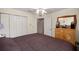 Bedroom with closet, dresser, and access to the ensuite bathroom at 11140 Sw 53Rd Cir, Ocala, FL 34476