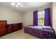 Small bedroom with purple bedding and hardwood style floors at 11140 Sw 53Rd Cir, Ocala, FL 34476