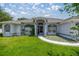 Charming single-story home featuring a well-manicured lawn and inviting front entry with arched window details at 11140 Sw 53Rd Cir, Ocala, FL 34476