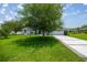A well-manicured lawn surrounds a home with mature trees providing shade and curb appeal at 11140 Sw 53Rd Cir, Ocala, FL 34476