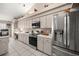 Well-lit kitchen featuring stainless steel appliances, ample cabinet space, and a neutral color palette at 11140 Sw 53Rd Cir, Ocala, FL 34476