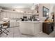 Spacious kitchen featuring a bar top, white cabinets, and tile flooring at 11140 Sw 53Rd Cir, Ocala, FL 34476