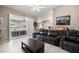 Cozy living room with tile floors, leather furniture, and sliding doors at 11140 Sw 53Rd Cir, Ocala, FL 34476