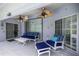 Covered patio with comfortable seating and ceiling fans at 11140 Sw 53Rd Cir, Ocala, FL 34476