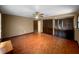 Spacious bedroom features hardwood floors, a ceiling fan with light, and two sets of closet doors at 11230 Se 47Th Ave, Belleview, FL 34420