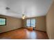 Bedroom with hardwood floors, a ceiling fan, and natural light from the windows illuminating the space at 11230 Se 47Th Ave, Belleview, FL 34420