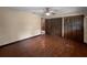 Bedroom with wood floors, ample closet space, ceiling fan and neutral paint at 11230 Se 47Th Ave, Belleview, FL 34420