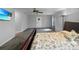 Cozy carpeted bedroom includes a TV and a door to the outside at 11230 Se 47Th Ave, Belleview, FL 34420