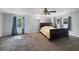 Bright bedroom with plush carpeting, ceiling fan, and multiple windows with curtains at 11230 Se 47Th Ave, Belleview, FL 34420