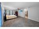 The bedroom features carpet, a TV, and an en suite bathroom entrance at 11230 Se 47Th Ave, Belleview, FL 34420