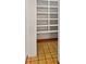 Walk-in closet featuring floor-to-ceiling shelving and patterned flooring at 11230 Se 47Th Ave, Belleview, FL 34420