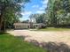 View of the front exterior of home with lush lawn and 3-car garage at 11230 Se 47Th Ave, Belleview, FL 34420