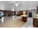 Spacious living room with a stone fireplace, tile flooring, and ample natural light at 11230 Se 47Th Ave, Belleview, FL 34420