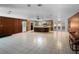 Open-concept living space with tile flooring, wood paneling and an island at 11230 Se 47Th Ave, Belleview, FL 34420