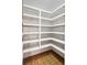Walk-in pantry with ample white shelving and patterned flooring at 11230 Se 47Th Ave, Belleview, FL 34420