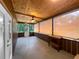Screened-in porch with wood paneling, a ceiling fan, and views of the outdoor greenery at 11230 Se 47Th Ave, Belleview, FL 34420