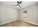 Cozy bedroom with neutral paint, updated flooring, and a bright window at 13314 Se 41St Ct, Belleview, FL 34420