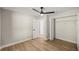 Bedroom featuring wood-look floors, large closet, and bright neutral paint at 13314 Se 41St Ct, Belleview, FL 34420