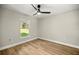 A simple bedroom with a ceiling fan and a view of the outside at 13314 Se 41St Ct, Belleview, FL 34420