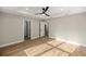 A spacious bedroom featuring wood flooring, a ceiling fan, and tray ceiling at 13314 Se 41St Ct, Belleview, FL 34420