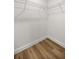 Walk-in closet features wood-look floors and wire shelving for optimal organization at 13314 Se 41St Ct, Belleview, FL 34420
