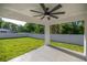 View of covered outdoor patio space featuring an outdoor ceiling fan and white vinyl fence at 13314 Se 41St Ct, Belleview, FL 34420