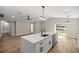Open living space with modern kitchen island, stainless appliances, and sliding glass door at 13314 Se 41St Ct, Belleview, FL 34420