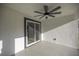 Covered patio with a contemporary ceiling fan and seamless access to the backyard at 13314 Se 41St Ct, Belleview, FL 34420