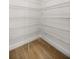 A walk-in closet that features wire shelving and wood flooring at 13314 Se 41St Ct, Belleview, FL 34420