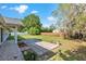 A spacious backyard featuring a well-maintained lawn, stone patio, and privacy fence at 1404 Se 40Th Ct, Ocala, FL 34471