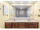 Bathroom featuring a double sink vanity, good lighting and large mirror at 1404 Se 40Th Ct, Ocala, FL 34471