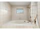 Large bathtub with tile surround and shower at 1404 Se 40Th Ct, Ocala, FL 34471