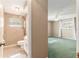 View from updated bathroom towards the sunlit bedroom with ceiling fan and green carpet at 1404 Se 40Th Ct, Ocala, FL 34471