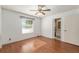 Bright bedroom featuring wood floors, a ceiling fan, and a window with natural light at 1404 Se 40Th Ct, Ocala, FL 34471