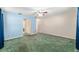 This spacious bedroom features an ample closet, ceiling fan, green carpet and a light blue wall at 1404 Se 40Th Ct, Ocala, FL 34471