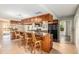 The kitchen features wood cabinets, granite counters, black appliances, and a breakfast bar with seating at 1404 Se 40Th Ct, Ocala, FL 34471