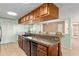 Kitchen features wood cabinets, granite counters, and black appliances at 1404 Se 40Th Ct, Ocala, FL 34471