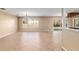 Spacious living room with tile floors, a modern chandelier, and a large window providing natural light at 1404 Se 40Th Ct, Ocala, FL 34471
