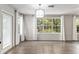 Bright sunroom with hardwood floors, large windows, and modern lighting at 1404 Se 40Th Ct, Ocala, FL 34471
