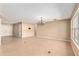 Expansive living area with neutral walls, tiled flooring, large windows, and a modern chandelier at 1404 Se 40Th Ct, Ocala, FL 34471