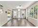 Bright sunroom with hardwood floors, large windows, and modern lighting at 1404 Se 40Th Ct, Ocala, FL 34471