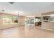 Open-concept living area featuring tiled floors, large windows, sliding glass doors, and a view of the kitchen at 1404 Se 40Th Ct, Ocala, FL 34471