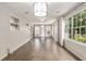 Bright living room with hardwood floors, large windows, and modern lighting at 1404 Se 40Th Ct, Ocala, FL 34471