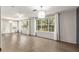 Bright living room with hardwood floors, large windows and modern lighting at 1404 Se 40Th Ct, Ocala, FL 34471