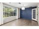 Bright living room featuring modern lighting, large windows, and hardwood floors at 1404 Se 40Th Ct, Ocala, FL 34471