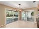 Bright sunroom with sliding glass doors, tiled floors, and an adjacent kitchen area at 1404 Se 40Th Ct, Ocala, FL 34471
