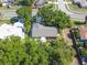 Overhead view of home with mature trees surrounding the yard at 15917 Hidden Lake Cir, Clermont, FL 34711