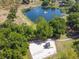 Aerial shot featuring a playground and pond with a fountain, all surrounded by mature trees at 15917 Hidden Lake Cir, Clermont, FL 34711
